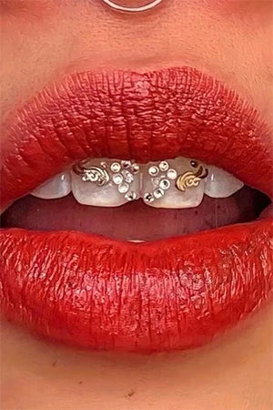 Tribal teeth jewelry and heart swarovski Tooth gems, winged heart tooth gems composition, woman teeth and red lips