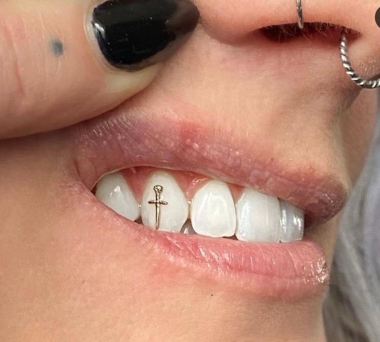 Tooth gems, gold roses and cross teeth jewelry